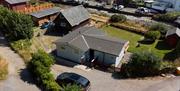 External photo of chalet - taken from above and showing entrance and car parking space