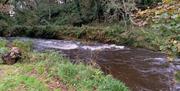 The barn has the Sulby River running alongside the meadow.