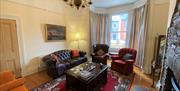 With period features and a fine collection of vintage furniture, art and decor items, the living room is the focal point of the house.