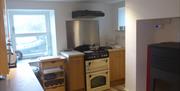 Kitchen with pellet boiler, electric cooker and underfloor heating
