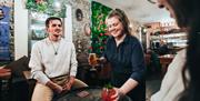 Couple being served drinks