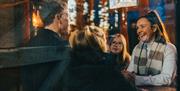 Family laughing inside The Coffee Cottage