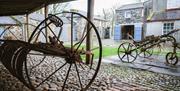 Old farm machinery in a barn at the back of the Grove House.