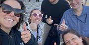 5 team members giving a thumbs up for completing their Douglas Quest.