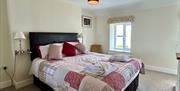 Bedroom 1 at Bay View Cottage - with a king -sized bed, generous wardrobe and washbasin - and sea views, of course!