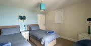 Bedroom 2 at Bay View Cottage - twin beds, a wardrobe and great sea views