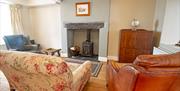 mariners cottage snug with sofas and log burner