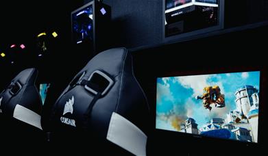 Gaming chairs in front of computer screens