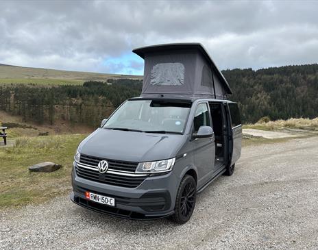 VW campervan set up at a sulby reservoir on the Isle of Man with the pop-top roof raised