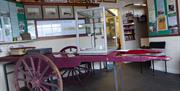 Inside the Museum and an original cart to carry the luggage of visitors to their hotels around Douglas Bay