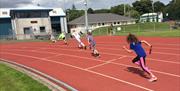 Children on the running track at the NSC Douglas