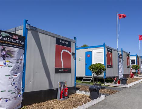Outside image of the IOMTT Village cabins.