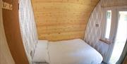A view of the bedroom with rear door out of the pod