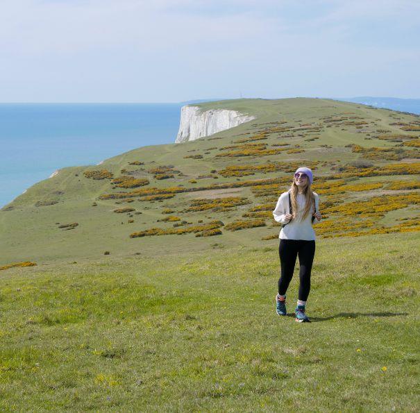 Lady walking along the cliff on the Isle of Wight