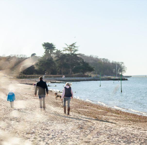 Family walking along the beach on the Isle of Wight