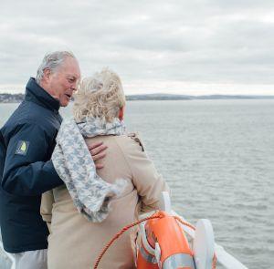 Couple on the deck of the Red Funnel Ferry looking out to sea