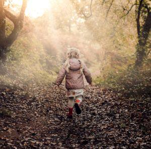 Child running through the forest on the Isle of Wight