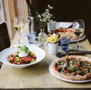 Variety of dishes and glasses of wine on a table at The Coast Restaurant & Bar on the Isle of Wight