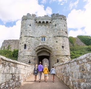 Family walking into Carisbrooke Castle on the Isle of Wight