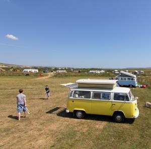 Children playing by a campervan within the countryside on the Isle of Wight