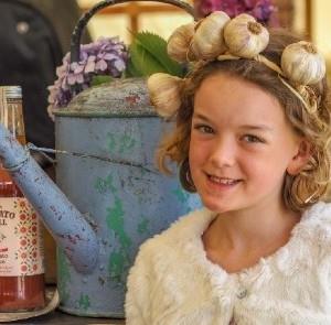 Girl with a garlic headband at the Isle of Wight Garlic Festival