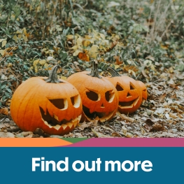 Pumpkins on the floor surrounded by leaves