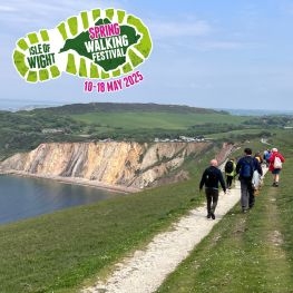 Group of walkers along the cliff walking towards the Needles during the Isle of Wight Walking Festival