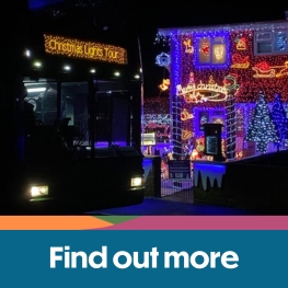 Southern Vectis bus in front of a house decorated with lights on the Isle of Wight