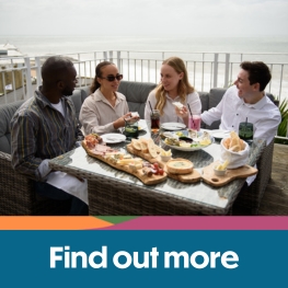 Group of friends eating on the balcony at The Wellington Hotel, Isle of Wight