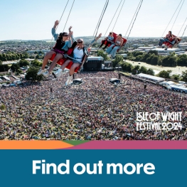 People riding on the high swing at the Isle of Wight Festival