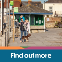 Family and their dog at the bus stop in Yarmouth on the Isle of Wight