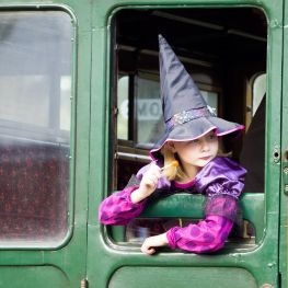 Girl dressed up as a witch on the train at the Isle of Wight Steam Railway October half term event