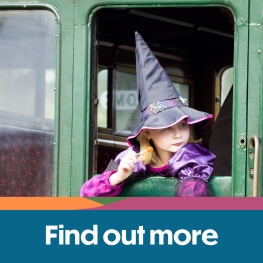 Girl dressed up as a witch looking out of the window on the train at the Isle of Wight Steam Railway