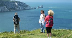Group standing on cliff with The Needles in the background, Isle of Wight Guided Tours, Things to Do