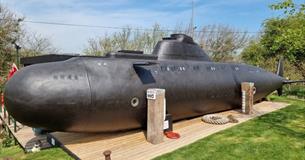 Outside view of HMS Bond submarine at Windmill Campersite, Isle of Wight, Glamping