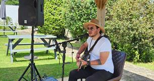 Ben Stubbs playing his guitar in the garden of Luccombe Hall Hotel, Shanklin, Isle of Wight, live music, performance,