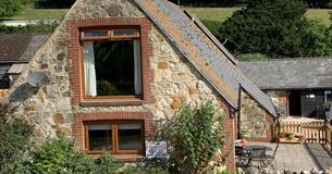 Isle of Wight, Accommodation, Brummell Barn, Image showing stone facade of barn.
