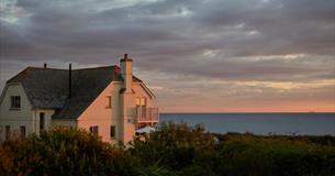Outside view of Flackstead with the sun setting behind, property with Classic Cottages, Isle of Wight, self catering, accommodation, luxury, cottages