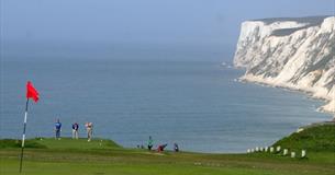 Group of people playing at Freshwater Golf Club with the English Channel in the background, Isle of Wight, activities