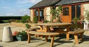 Outside view of Rose Cottage with outdoor picnic table, Atherfield Green Farm Holiday Cottages, Chale, Self Catering