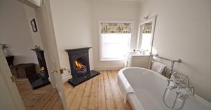 Roll-top bath with open fire at Signal Point, Ventnor Botanic Garden, Self Catering, Isle of Wight