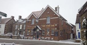 Outside view of The Vine Inn in the snow, pub, St Helens