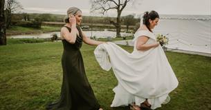 Isle of Wight, Wedding Venue, Westover Farm, Calbourne, Bride and Bridesmaid walking in front of lake
