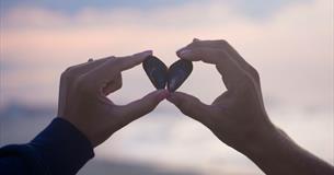 Couple holding a shell in the shape of a heart, The Seaview Hotel Valentines package, Isle of Wight
