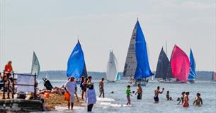 People swimming in the sea watching the boats sailing, Cowes Week, event, what's on