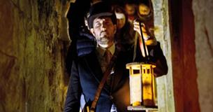 Man with a lantern exploring Carisbrooke Castle in the dark, Halloween event, what's on, Isle of Wight