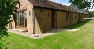 Outside view of Lacewood barn surrounded by garden, Fernhill Barns, Wootton, Isle of Wight, self-catering