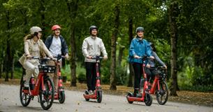 Group of people hiring electric bikes and electric scooters from Voi, getting around, Isle of Wight, bike hire, cycling
