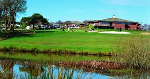Shanklin & Sandown Golf Club's course and lake with the clubhouse in the background, Isle of Wight, activity