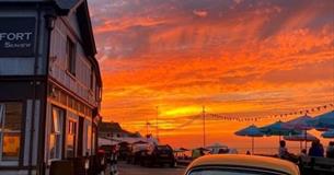 Outside view of The Old Fort with a sunset over the sea, Seaview, Isle of Wight, food & drink
